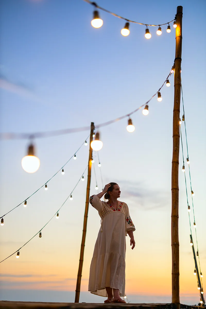 Girl at Ao Tapao pier on Koh Kood island in Thailand watching sunset
