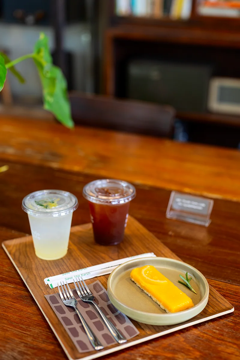 Lemon tart dessert and drinks on wooden table - Piccolo Vicolo cafe in Bangkok