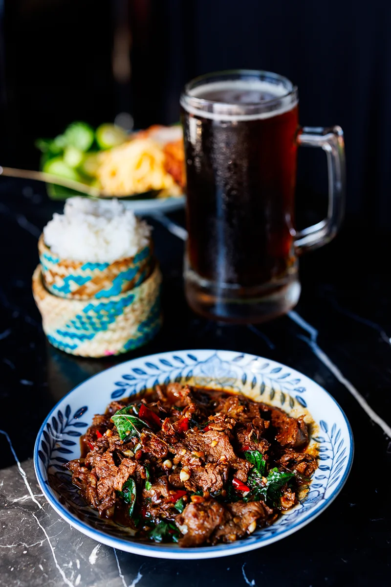 Spicy Thai beef dish with rice and drink - Rongros restaurant in Bangkok