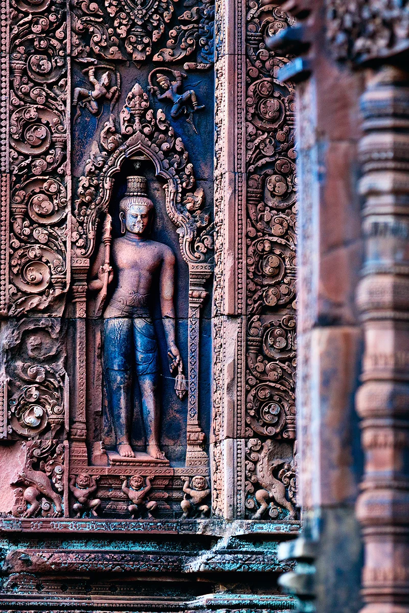 Remarkably preserved detailed carvings in pink sandstone at Banteay Srei temple in Angkor