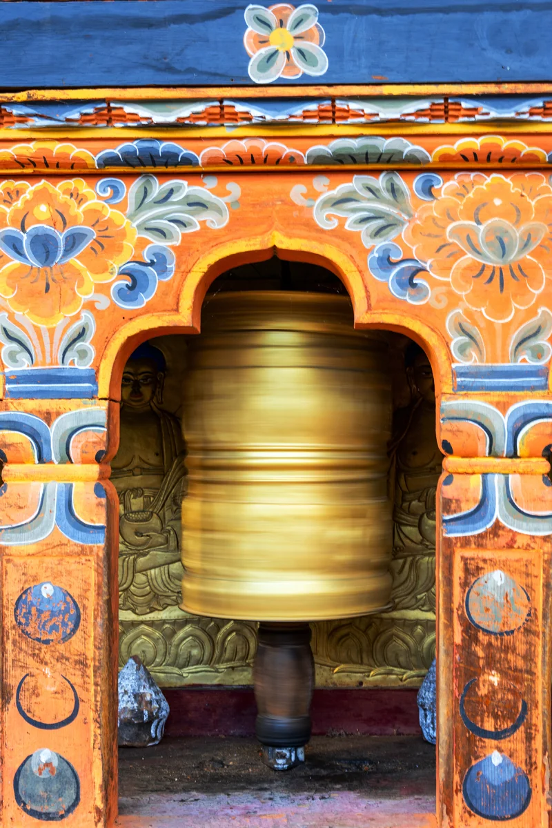 Golden prayer wheel in ornate structure