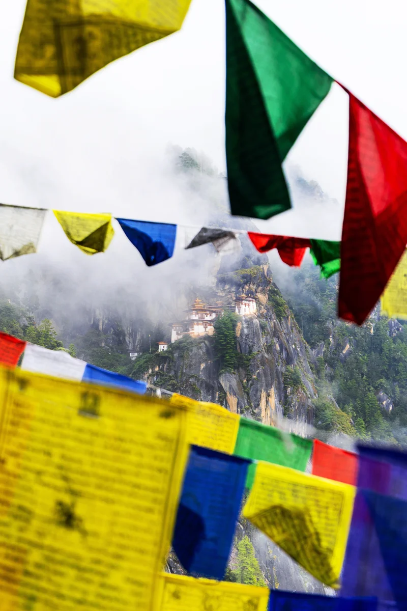 Colorful flags with Tiger's Nest monastery backdrop