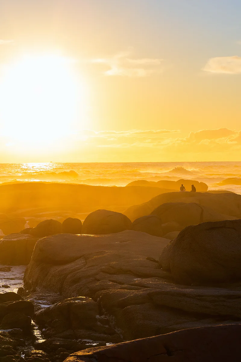 watching the sunset from Maiden’s Cove at Camps Bay Beach is one of the best things to do in Cape Town
