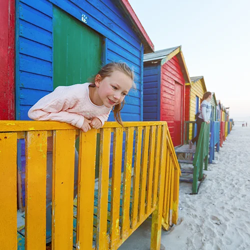 One of the best things to do in Cape Town is visit colorful changing huts at Muizenberg beach