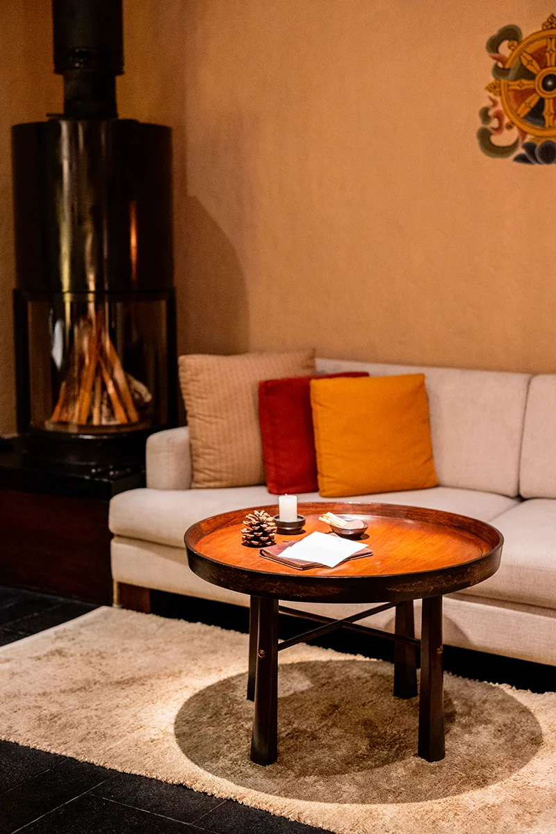 Cozy living room with wooden table - Gangtey Lodge in Bhutan