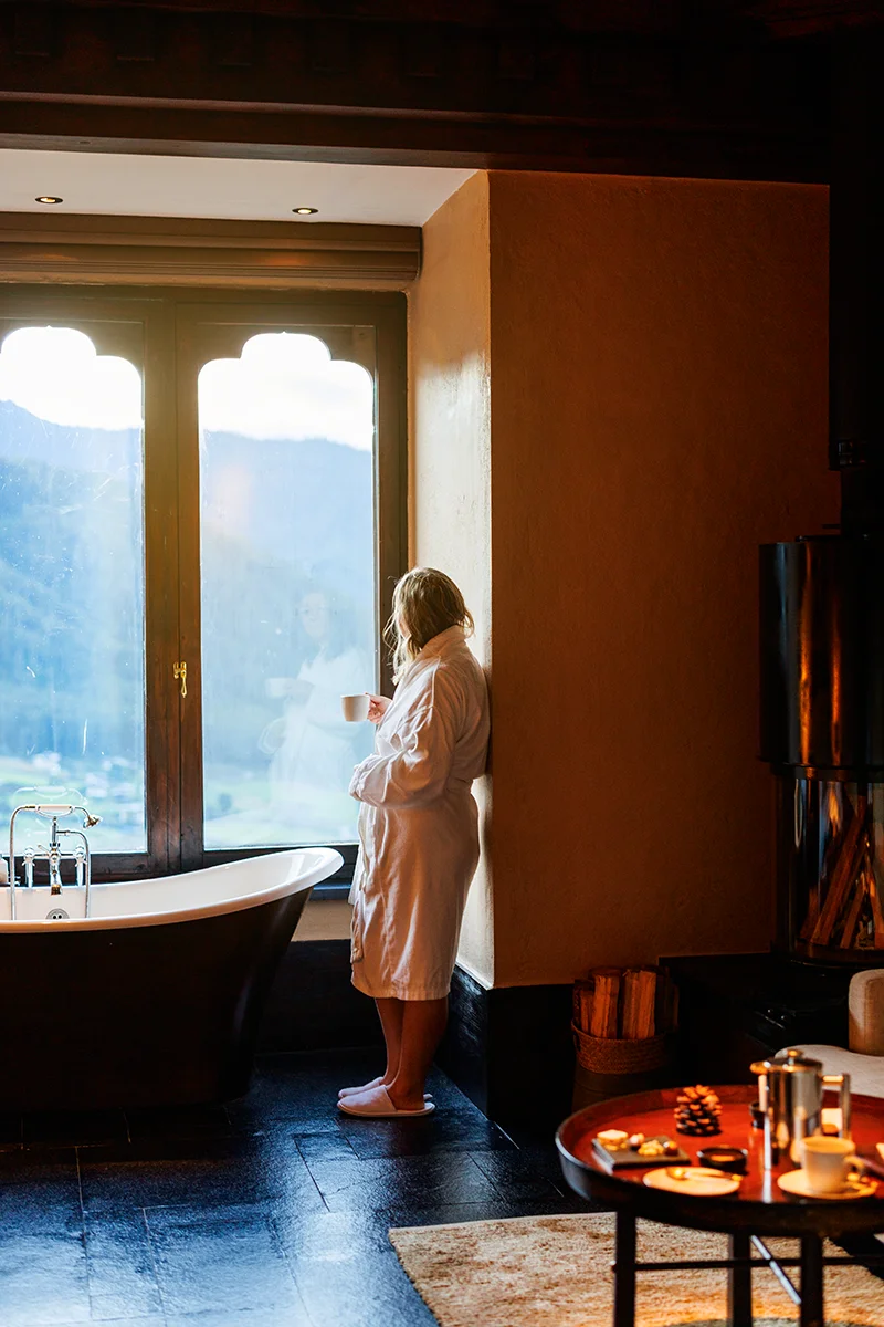 Person enjoying a serene view from Gangtey Lodge room