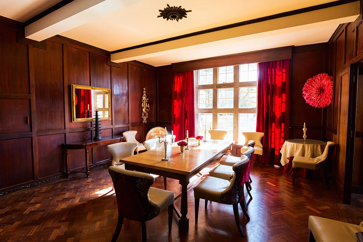 Interior of common dining room in historic Giraffe Manor hotel in Kenya