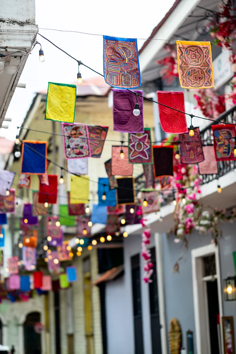 Colorful molas hanging in alleyway