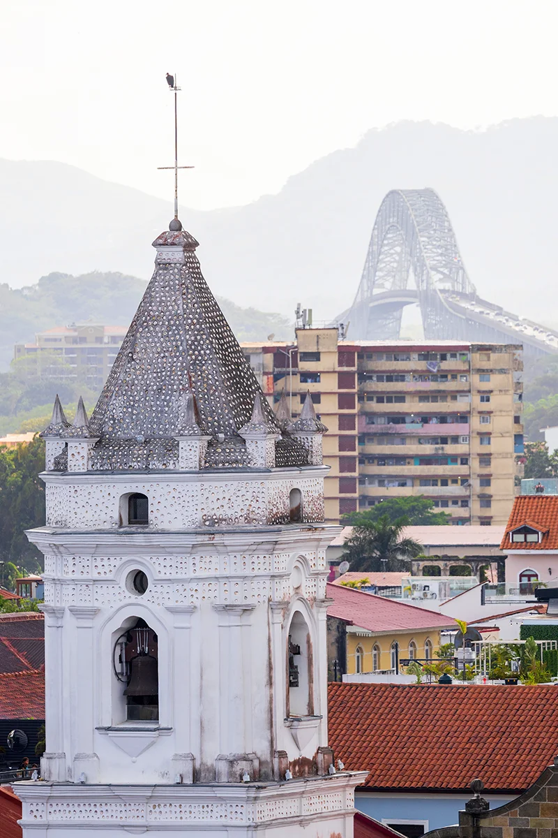 Historic tower with modern bridge backdrop – Panama City