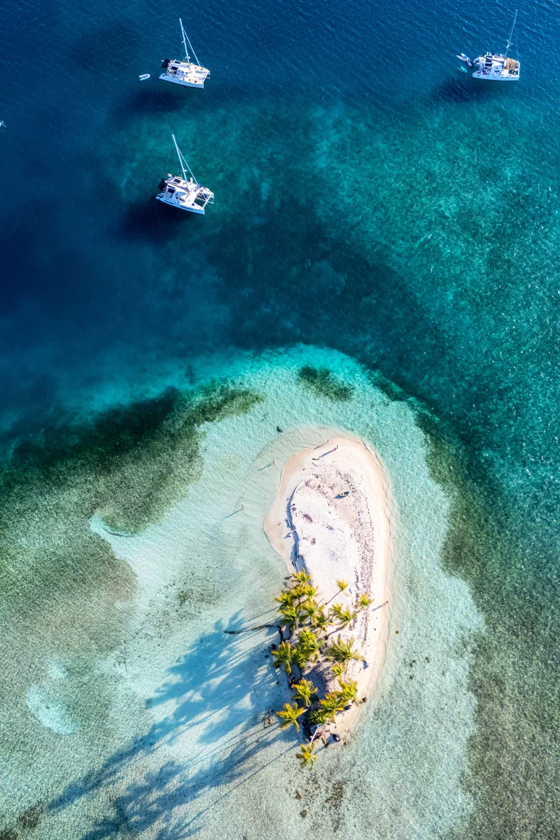 Tropical island with boats nearby