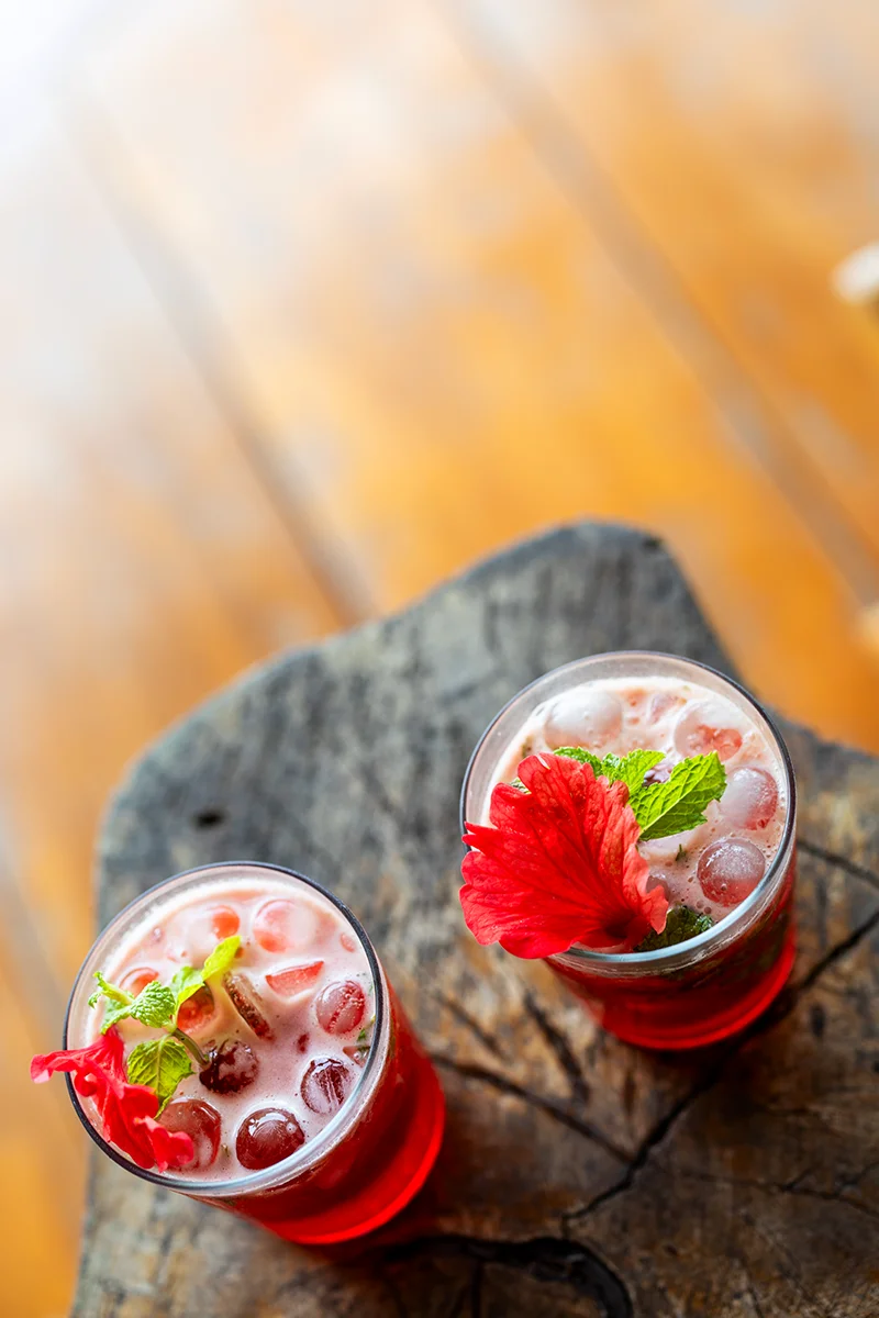 Two colorful drinks with flowers