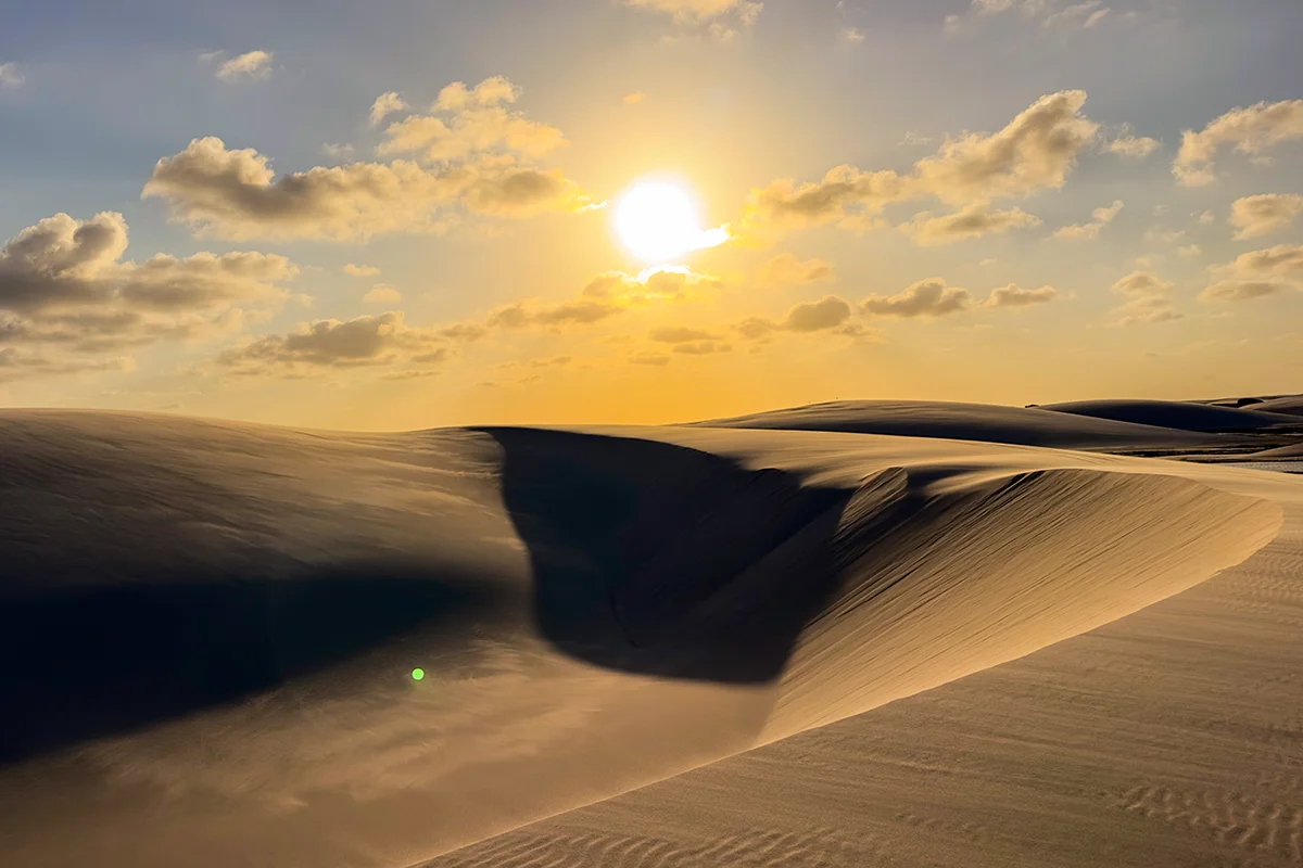 Sunset over sandy dunes landscape