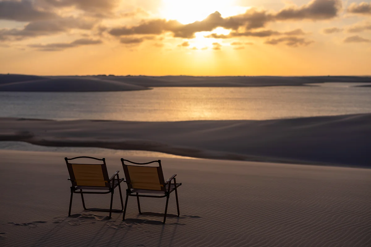 Chairs overlooking a serene sunset in Lençóis Maranhenses National Park