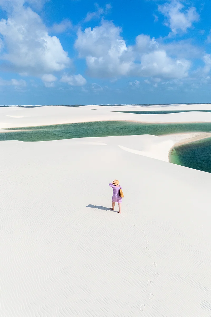 Woman walking on white sand dunes