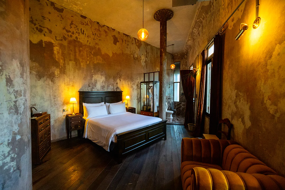 Rustic bedroom with warm lighting in The Mustang Blu boutique hotel in Bangkok