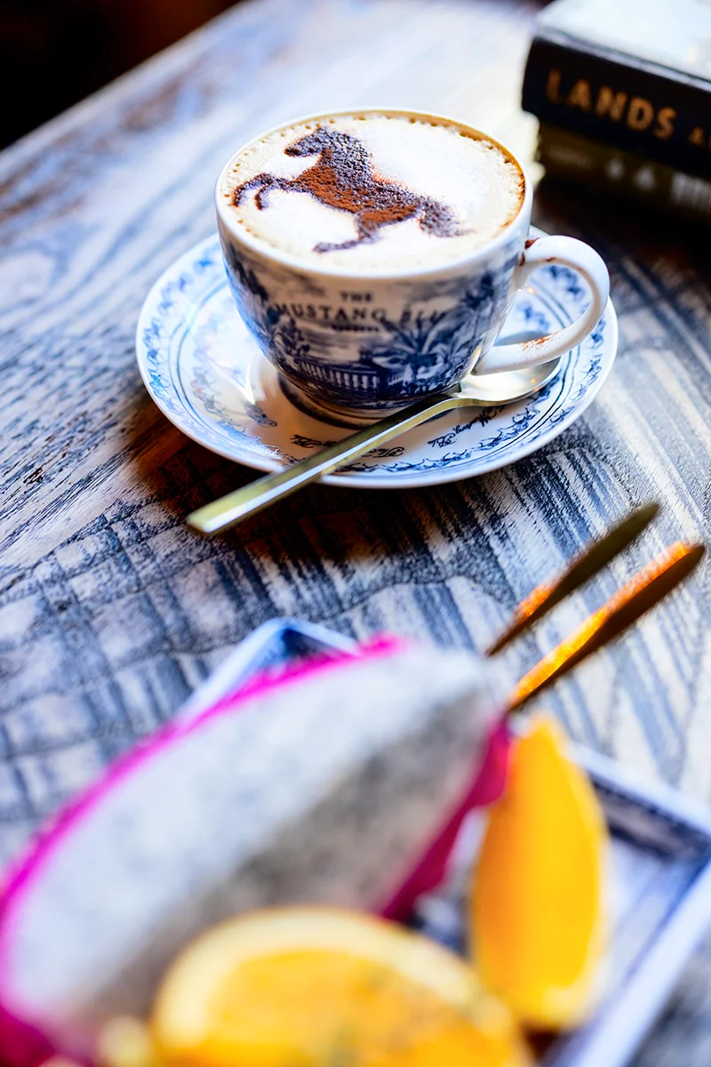 Coffee with horse design and fresh fruits