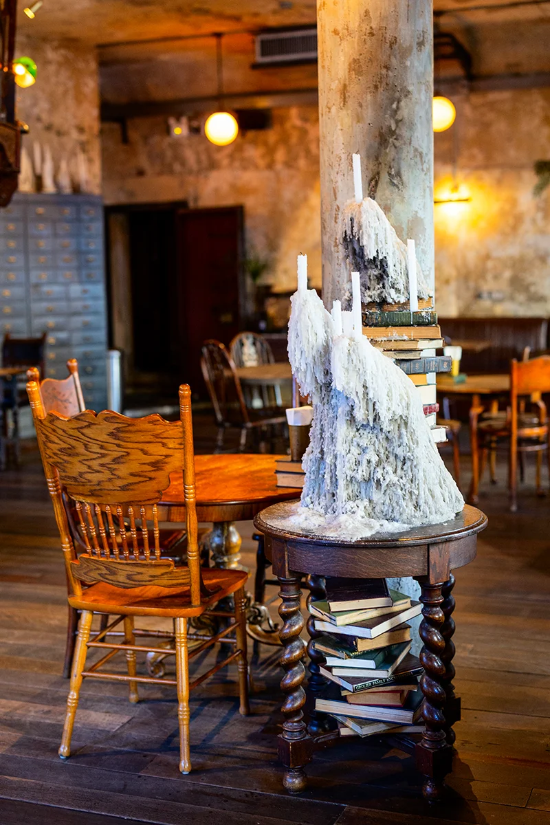 Rustic decor with candles and books in The Mustang Blu in Bangkok