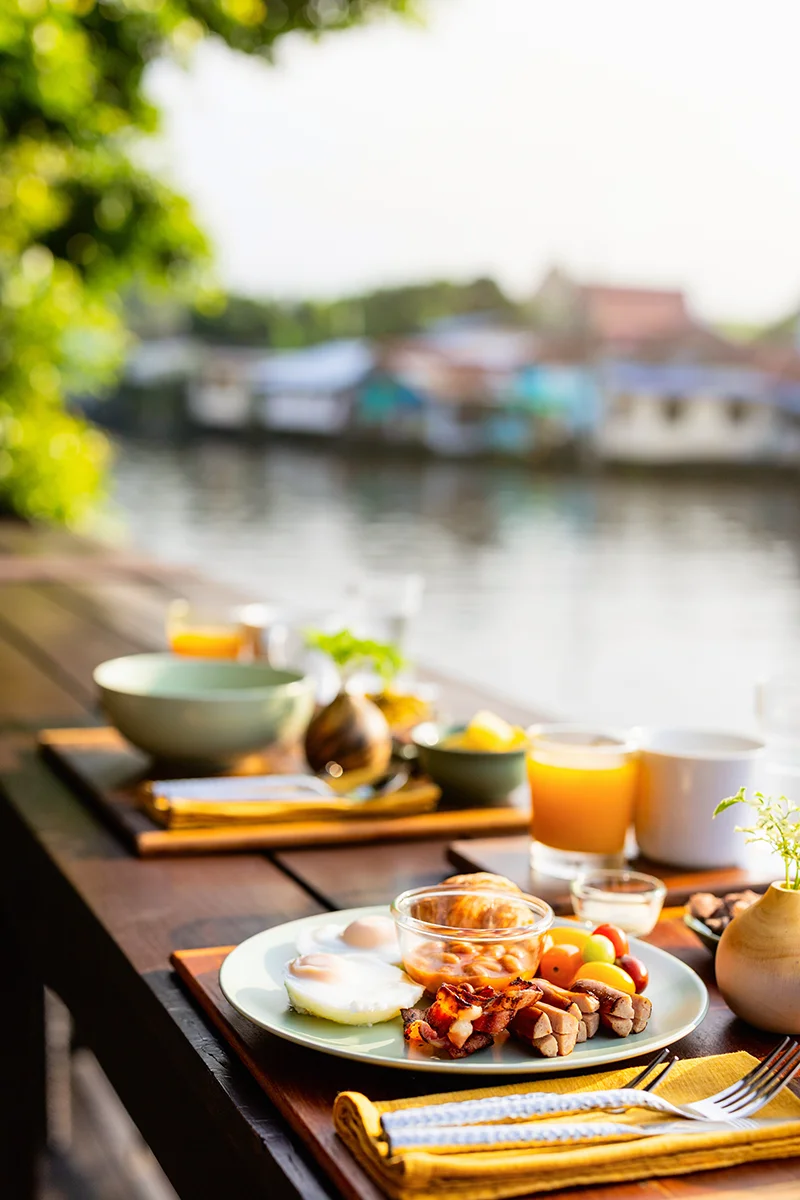 Breakfast on the patio overlooking the canal at Neil Niwas