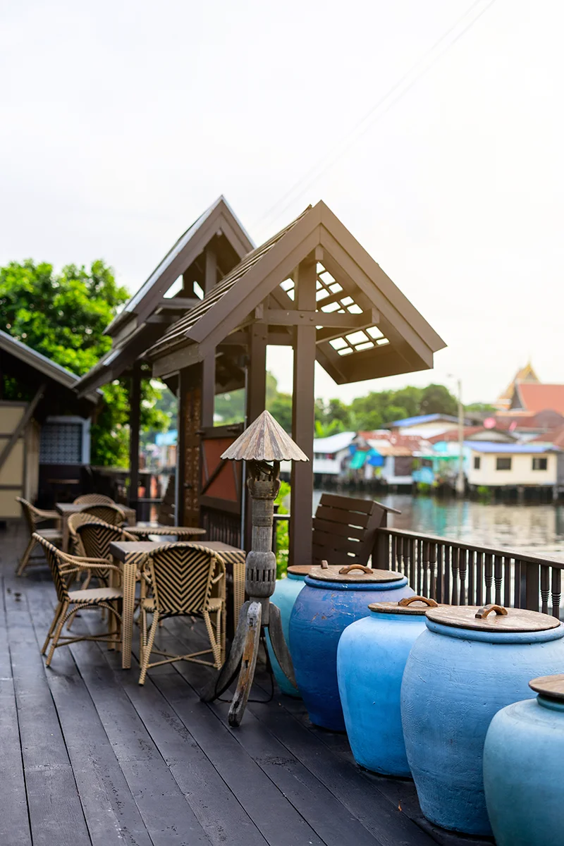 Charming riverside seating with pottery at Neil Niwas hotel in Bangkok