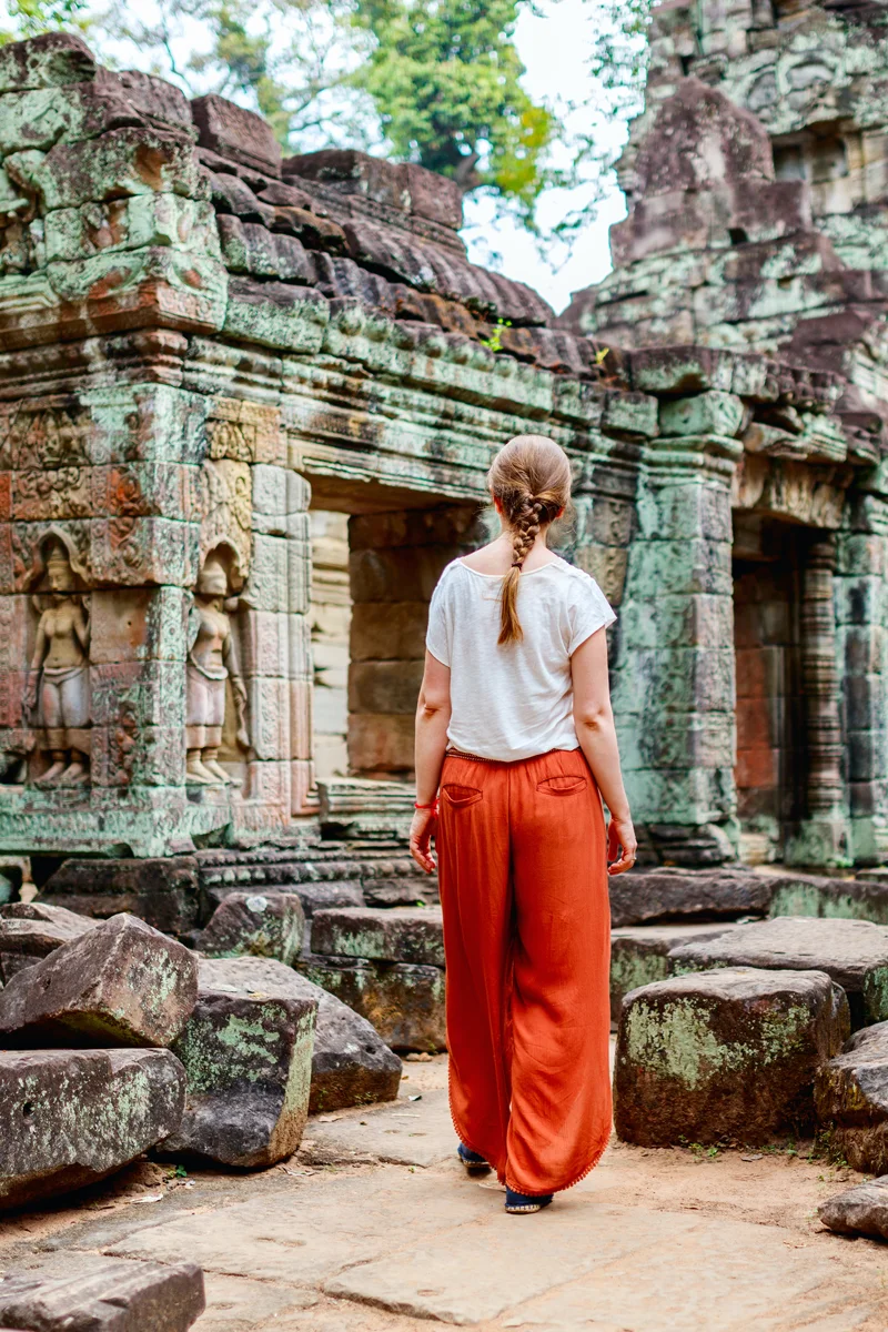 A tourist visiting lesser-known Preah Khan temple in Angkor built in 12th century