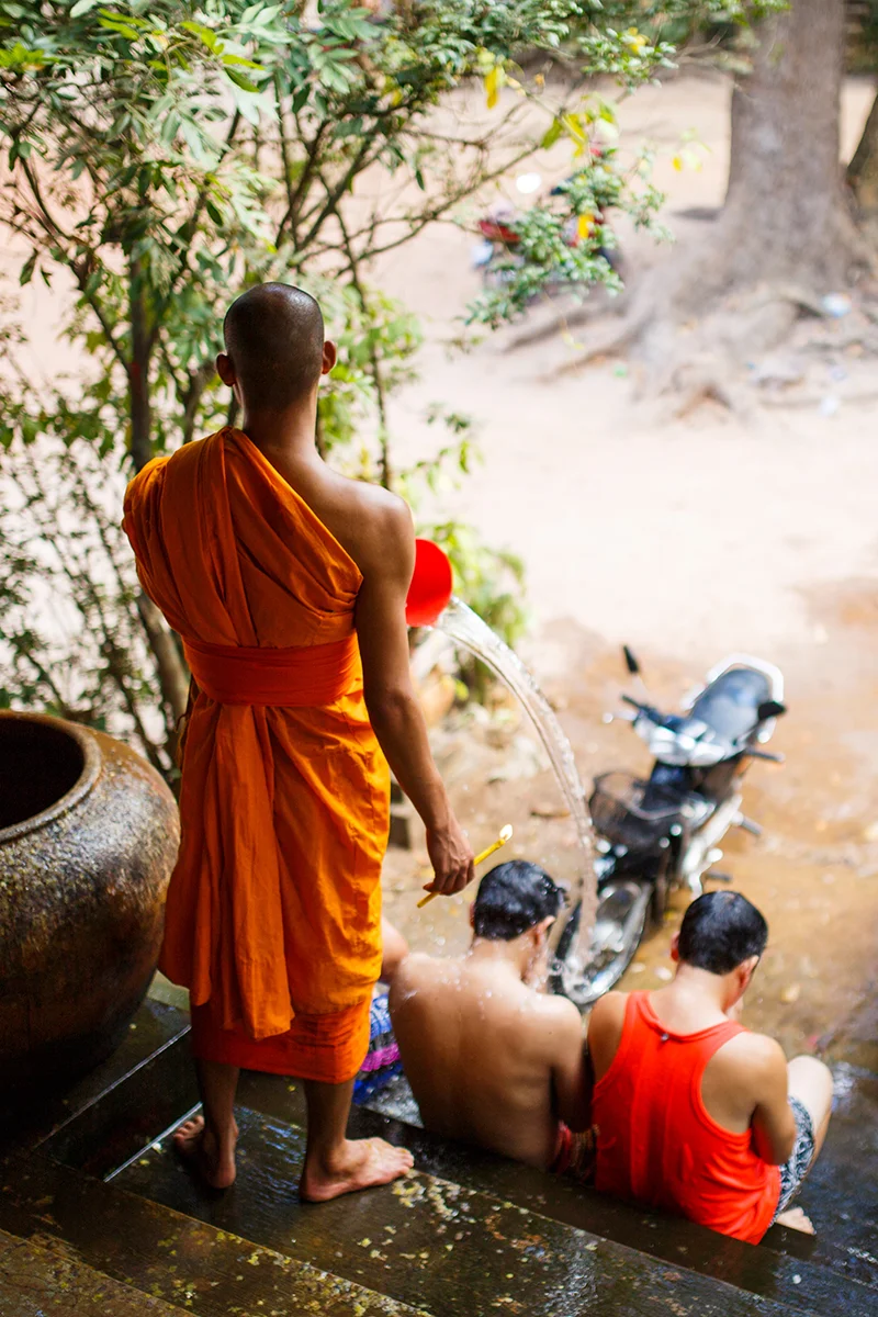 Buddhist monk performing sacred Water Blessing Ceremony in Cambodia