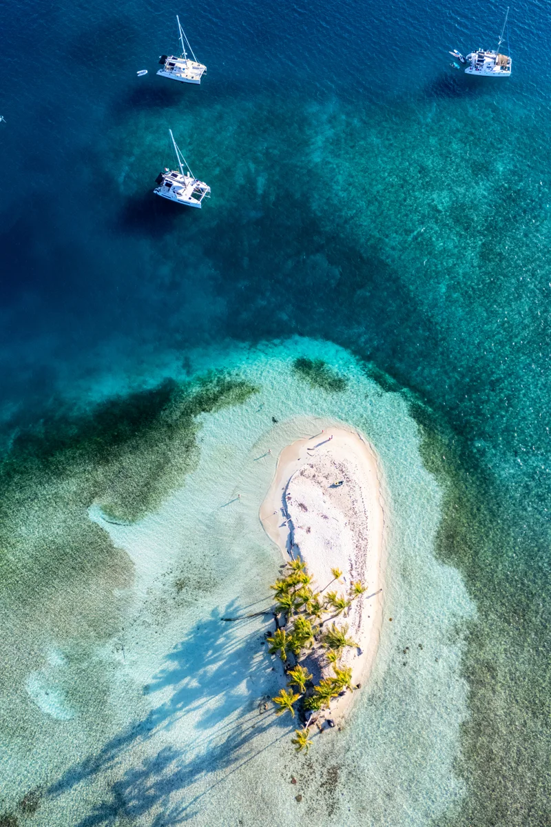 Tropical island with boats nearby