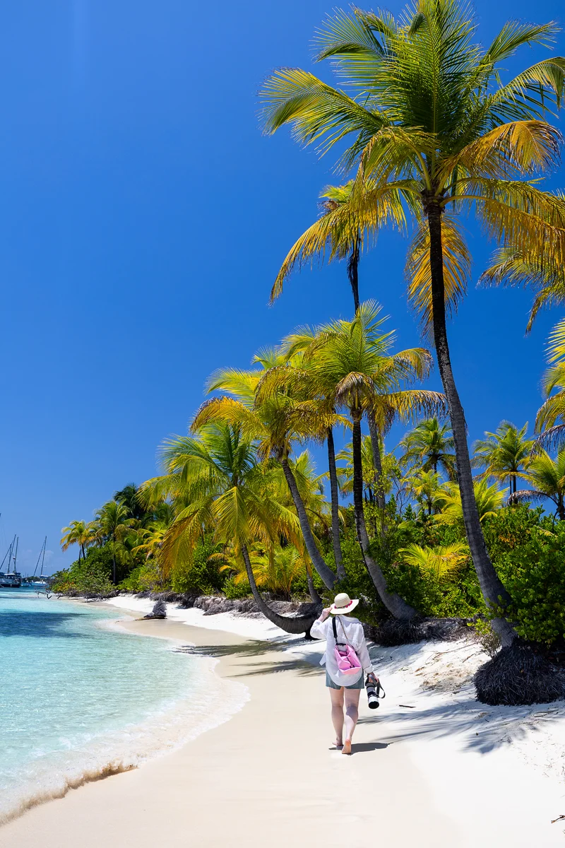 Woman walking on tropical beach of Coco Blanco Island in Guna Yala Panama