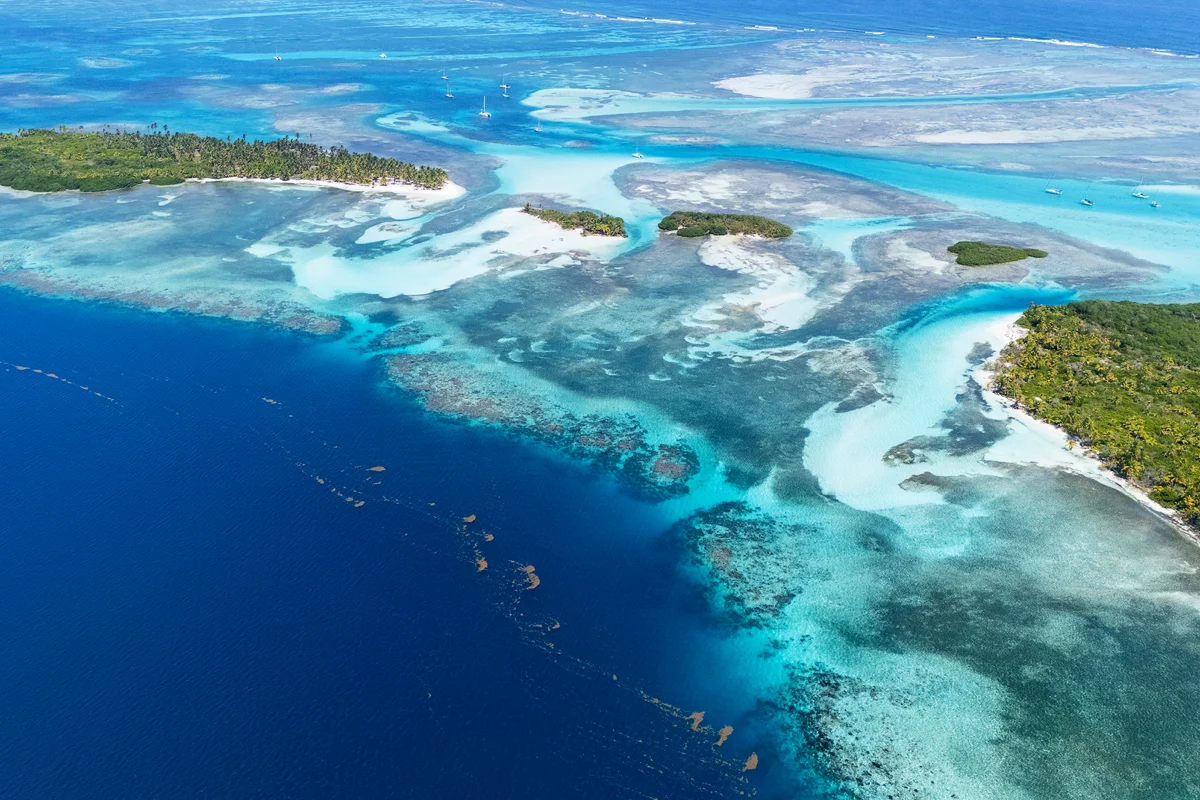 Above view of vibrant turquoise waters and islands in Guna Yala Panama