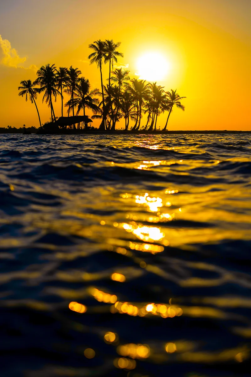 Sunrise over tropical Emoji Island silhouette in Guna Yala Panama