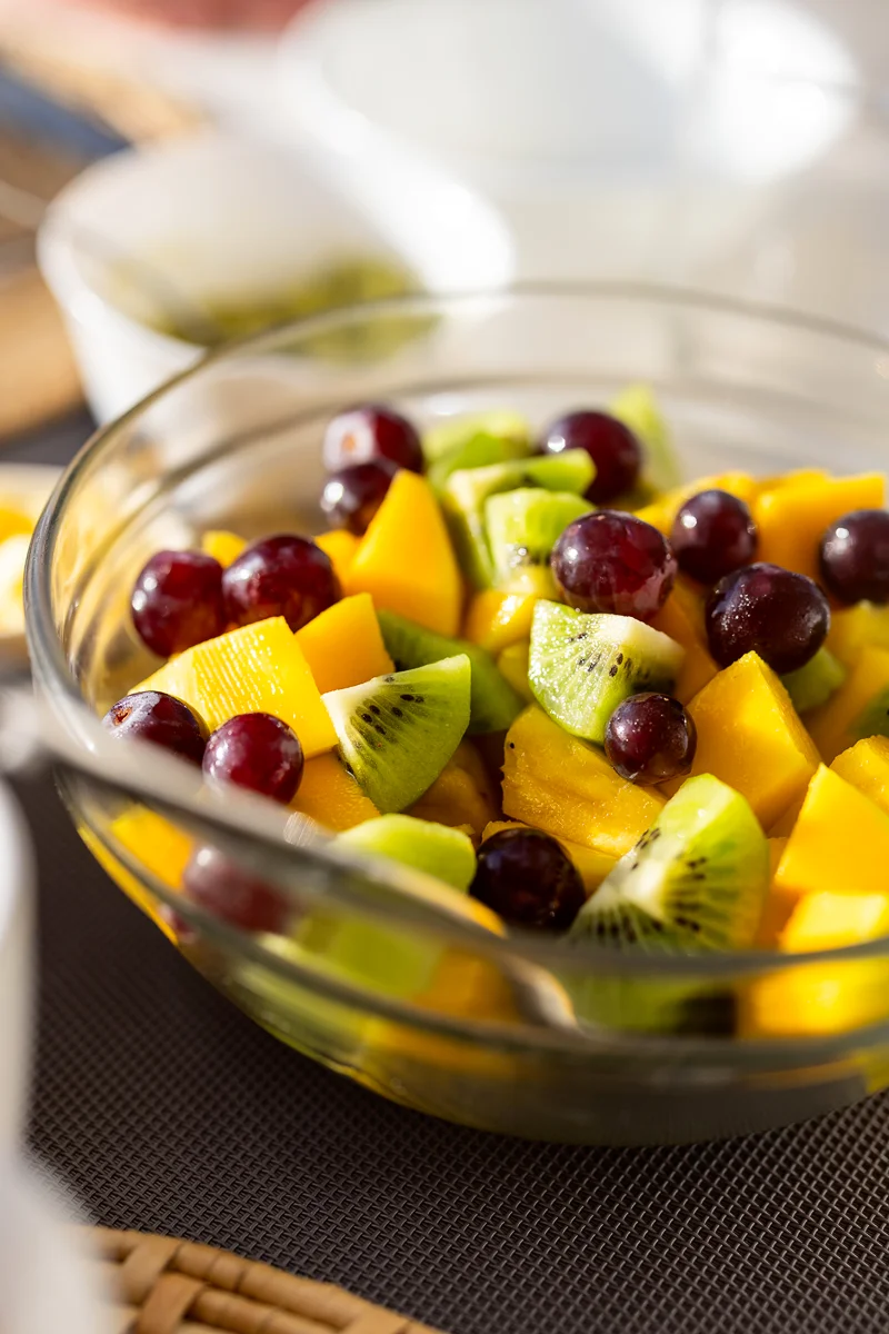 Colorful fruit salad in glass bowl