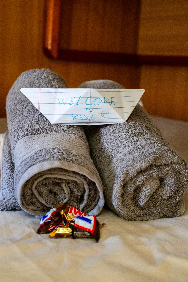 Towels and chocolate welcome note.