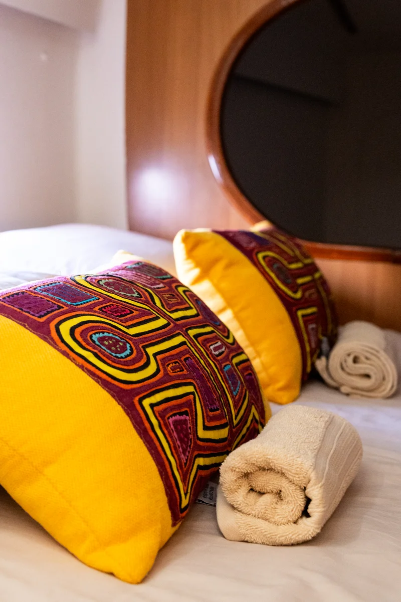 Colorful pillows with molas and rolled towels