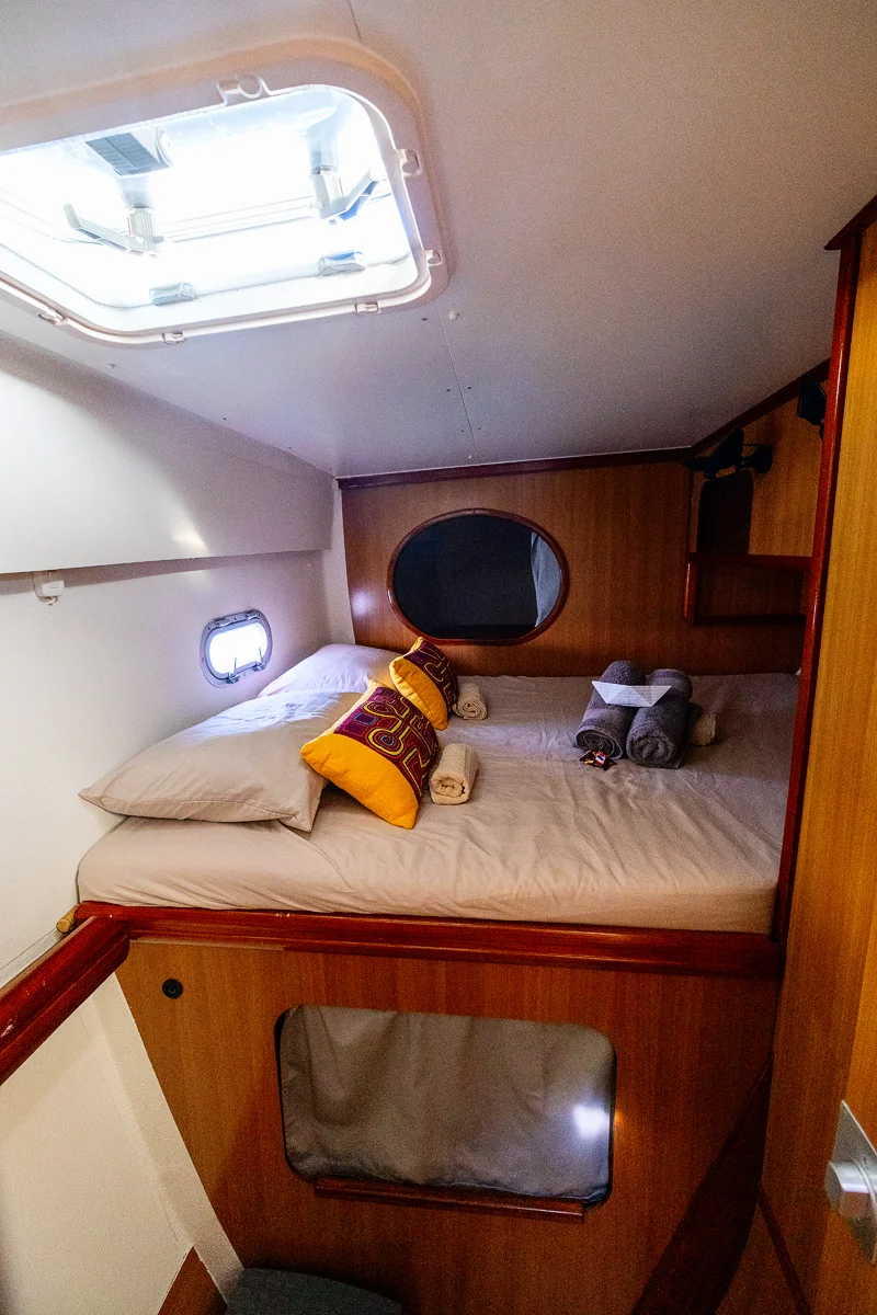 Cozy cabin with bedding and pillows at catamaran