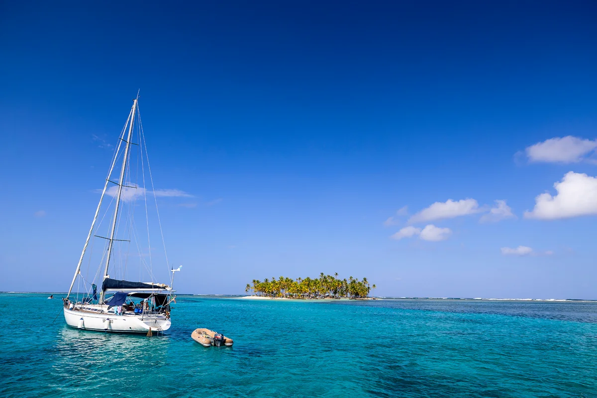 Sailboat near tropical island paradise, San Blas Islands Panama