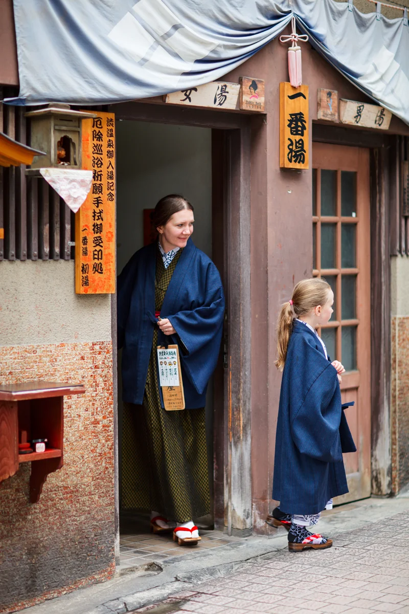 Mother and child wearing traditional Japanese attire in hot spring town of Shibu Onsen