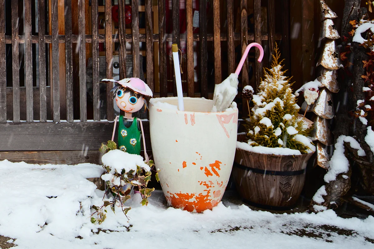 Doll and pots in snowy setting
