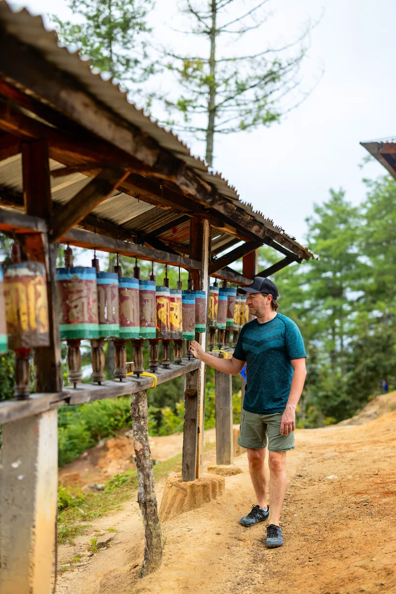 Person spinning prayer wheels