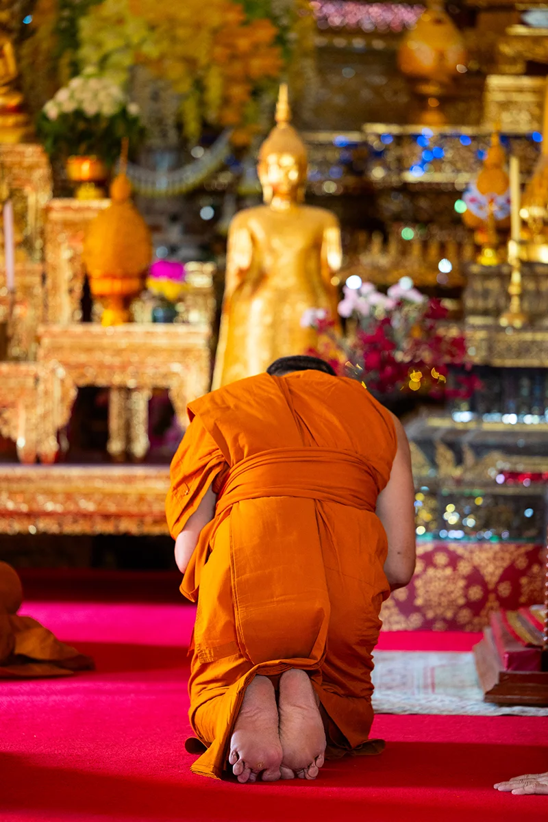 Monk praying at Wat Arun temple in Bangkok